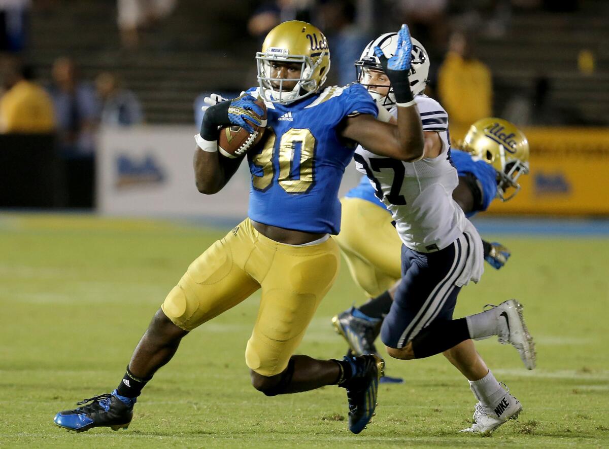 UCLA linebacker Myles Jack intercepts a pass to seal a 24-23 victory over BYU at the Rose Bowl on Saturday.