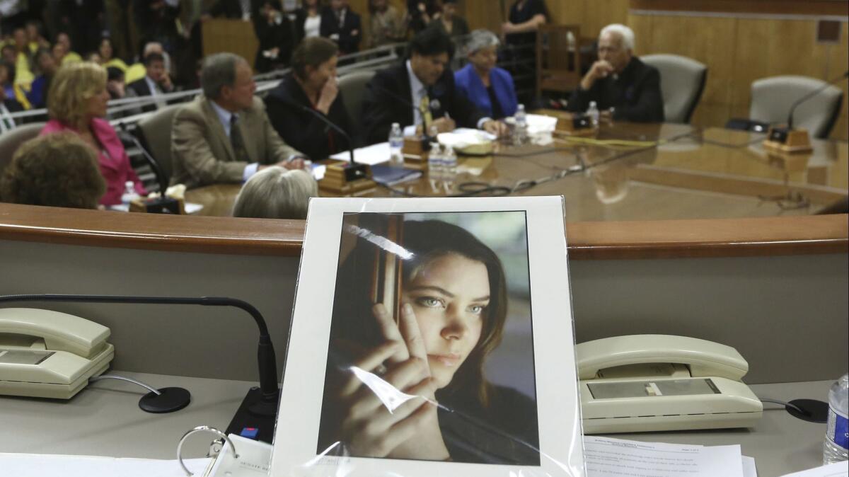 A portrait of Brittany Maynard sits on the dais of the Senate Health Committee at the Capitol in Sacramento, Calif. on March 25, 2015.