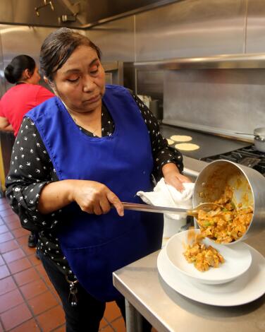 Rincon Hondureno owner and chef Blanca Perez, makes candinga at her Los Angeles eatery on W. Adams Blvd., in Los Angeles on Friday, April 28, 2023.