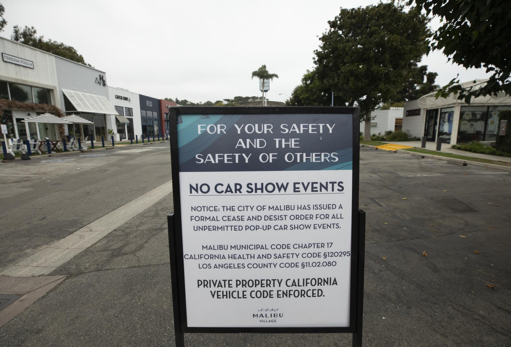 A sign warns against "unpermitted pop-up car show events" at the Malibu Village Shopping Mall.