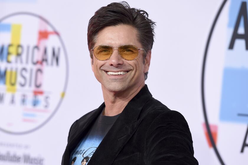 John Stamos arrives at the American Music Awards on Tuesday, Oct. 9, 2018, at the Microsoft Theater in Los Angeles. (Photo by Jordan Strauss/Invision/AP)