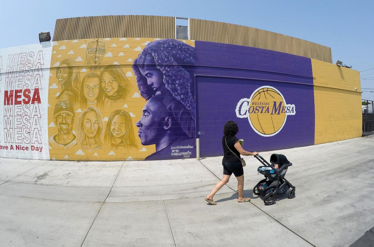 A mural on the side of Social nightclub depicts Kobe and Gianna Bryant in purple, and the faces of those who also died.