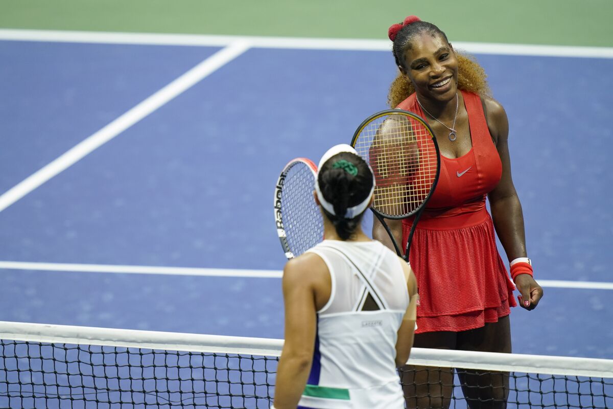 Serena Williams, of the United States, top taps rackets with Kristie Ahn, of the United States, after winning their first-round match of the US Open tennis championships, Tuesday, Sept. 1, 2020, in New York. (AP Photo/Seth Wenig)