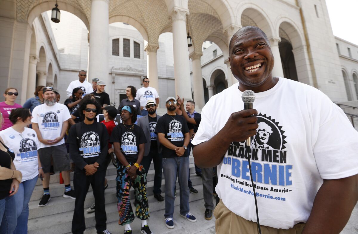 Bruce Carter, founder of "Black Men for Bernie," talks to supporters in front of Los Angeles City Hall. The group is campaigning for Democrataic presidential candidate Bernie Sanders in a tour bus wrapped in this slogan.
