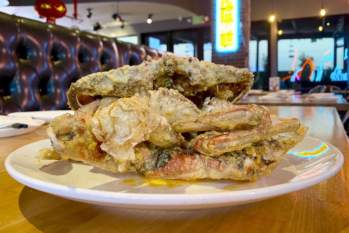Pieces of fried crab stacked on a plate in a restaurant