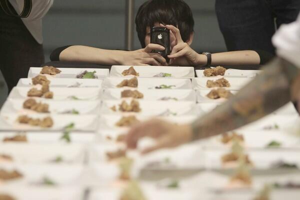 It's food as theater as Rachel Coleman takes photographs of the desserts being prepared.