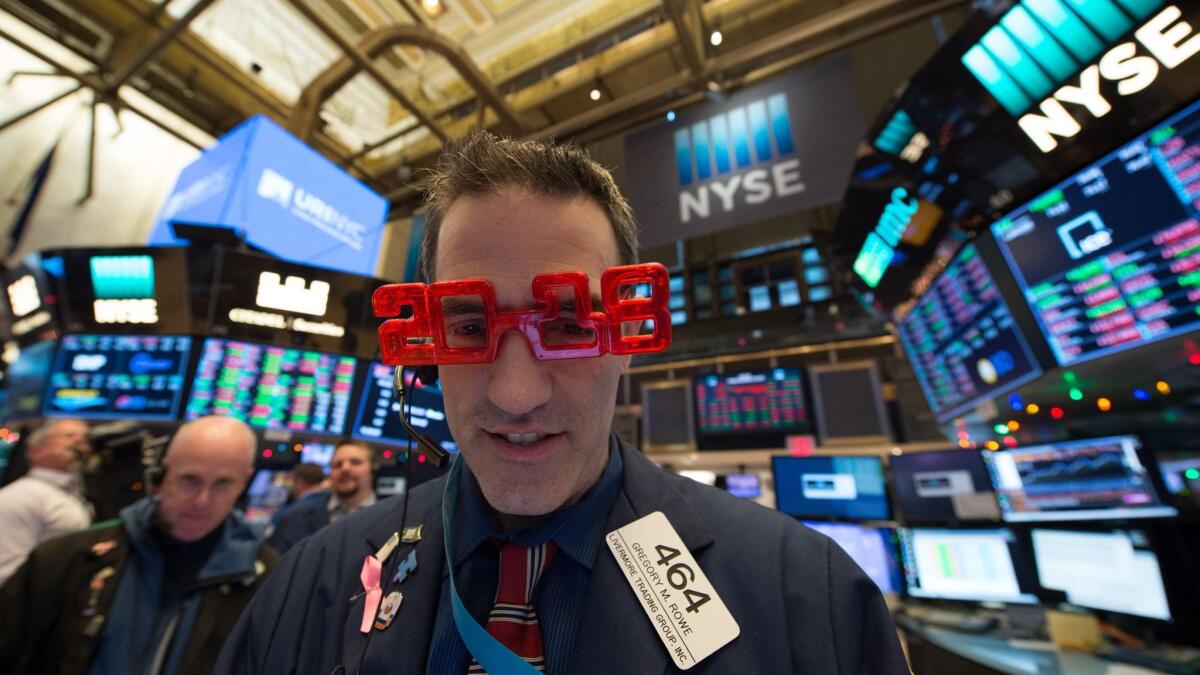 A trader wears "2018" glasses at the New York Stock Exchange on Friday.