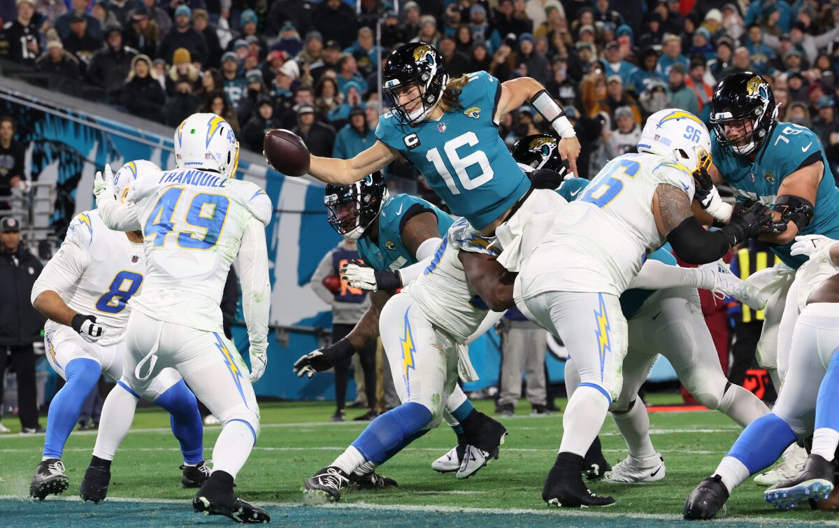 Trevor Lawrence of the Jaguars leaps with the football.