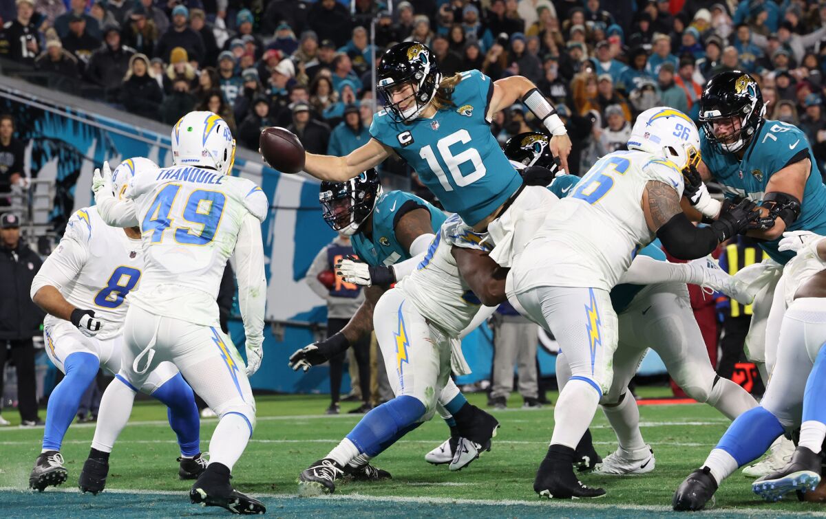 Jacksonville Jaguars quarterback Trevor Lawrence scores on a two-point conversion attempt.