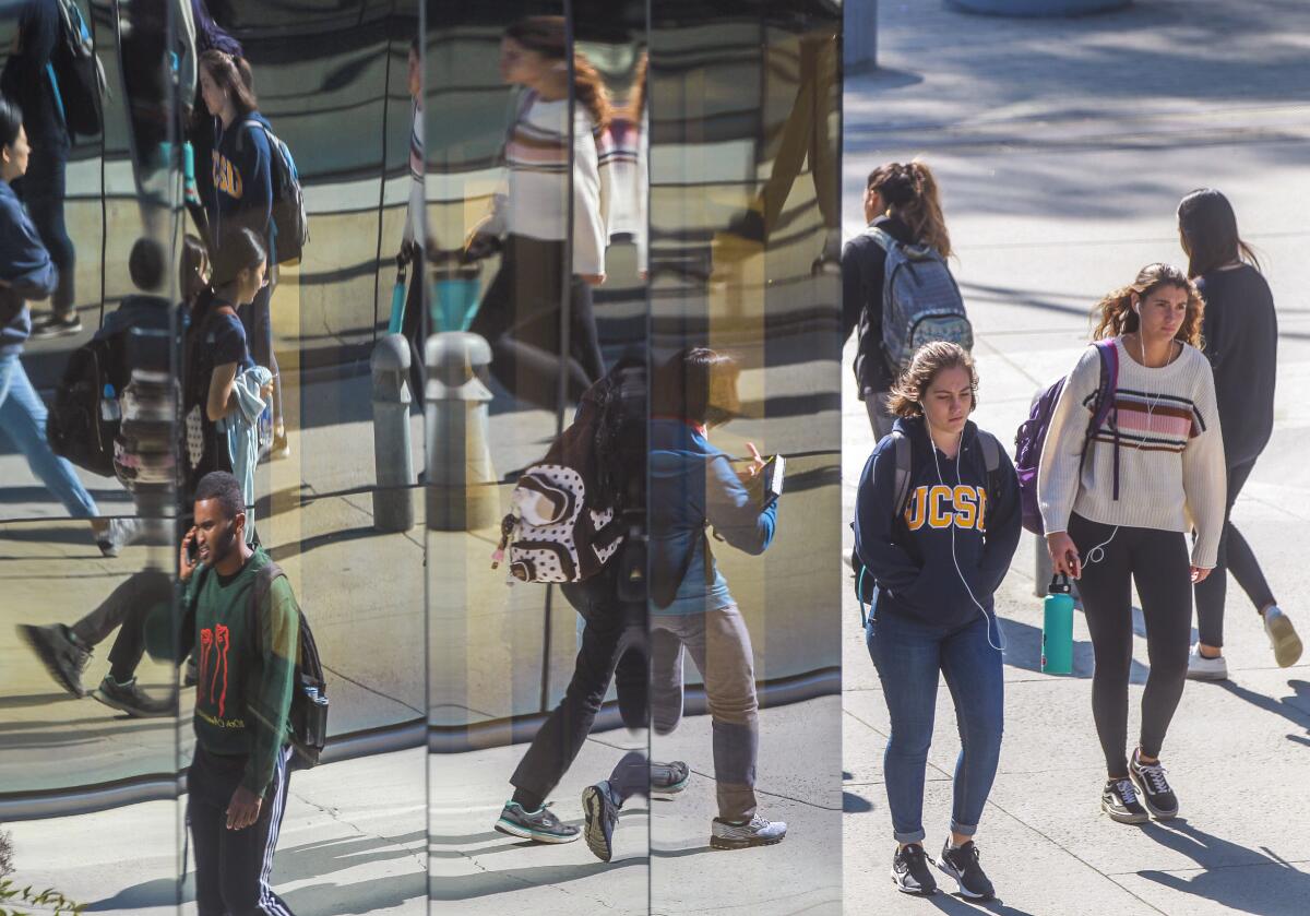 Students walk near the entrance to the Geisel Library at the UCSD campus