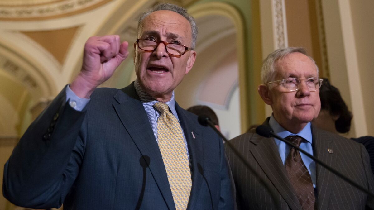 Sen. Charles Schumer, D-N.Y., joined at right by Senate Minority Leader Harry Reid of Nev., criticizes Republican lawmakers for being too tied to the NRA and the gun lobby on June 14.