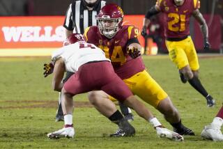 USC defensive lineman Kobe Pepe brings down Washington State quarterback Jayden de Laura 