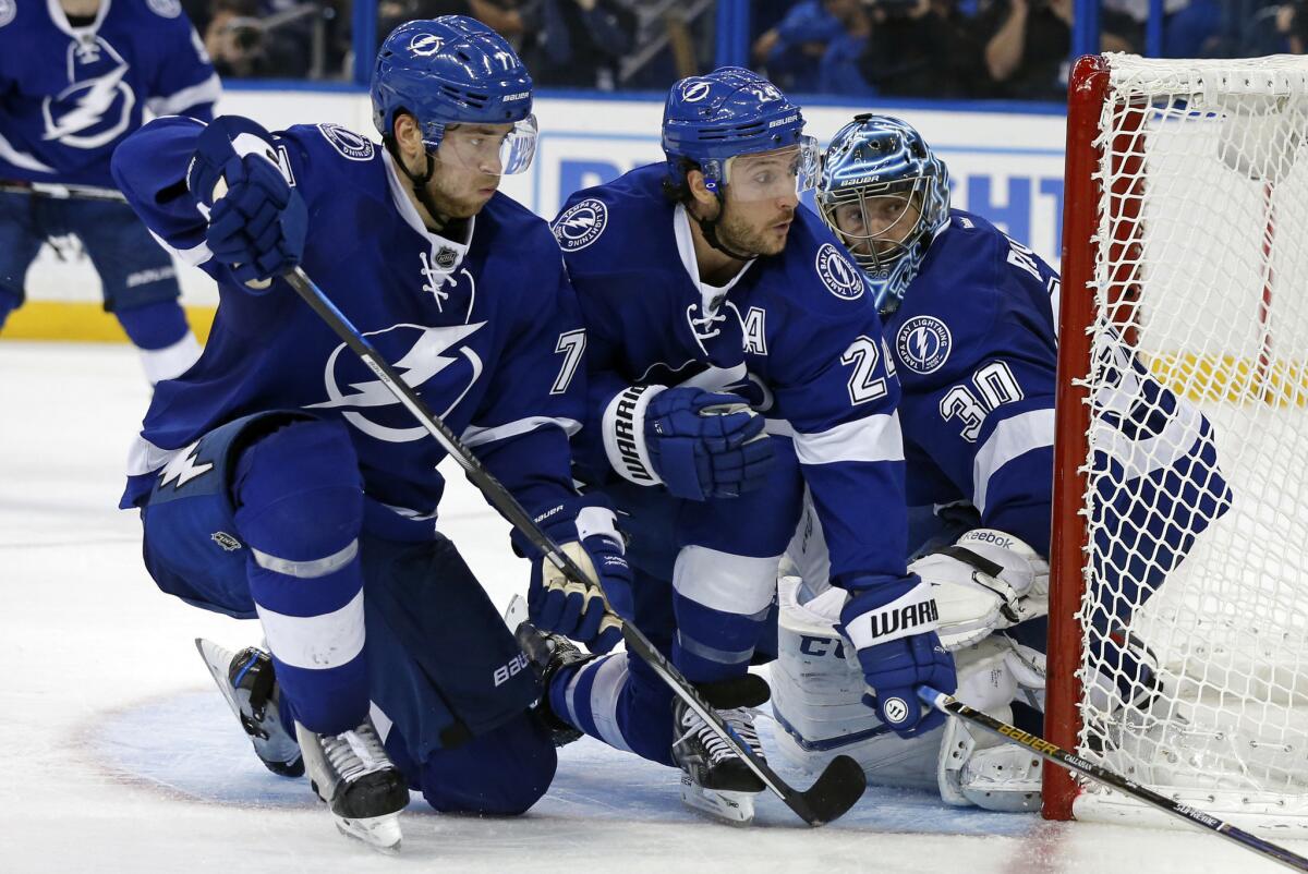 Victor Hedman (77) Ryan Callahan (24) and Ben Bishop (30) of the Lightning defend the net during a playoff game against the Red Wings on April 21.