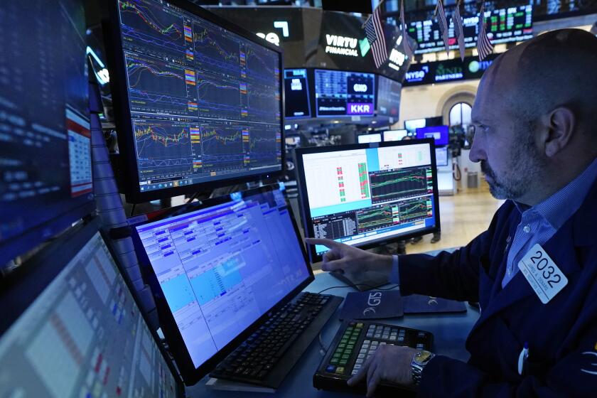 FILE - Specialist James Denaro works at his post on the floor of the New York Stock Exchange, Wednesday, Nov. 15, 2023. Stocks edged higher in morning trading on Wall Street Wednesday, Nov. 29, following some encouraging updates from U.S. companies, including General Motors. (AP Photo/Richard Drew, File)