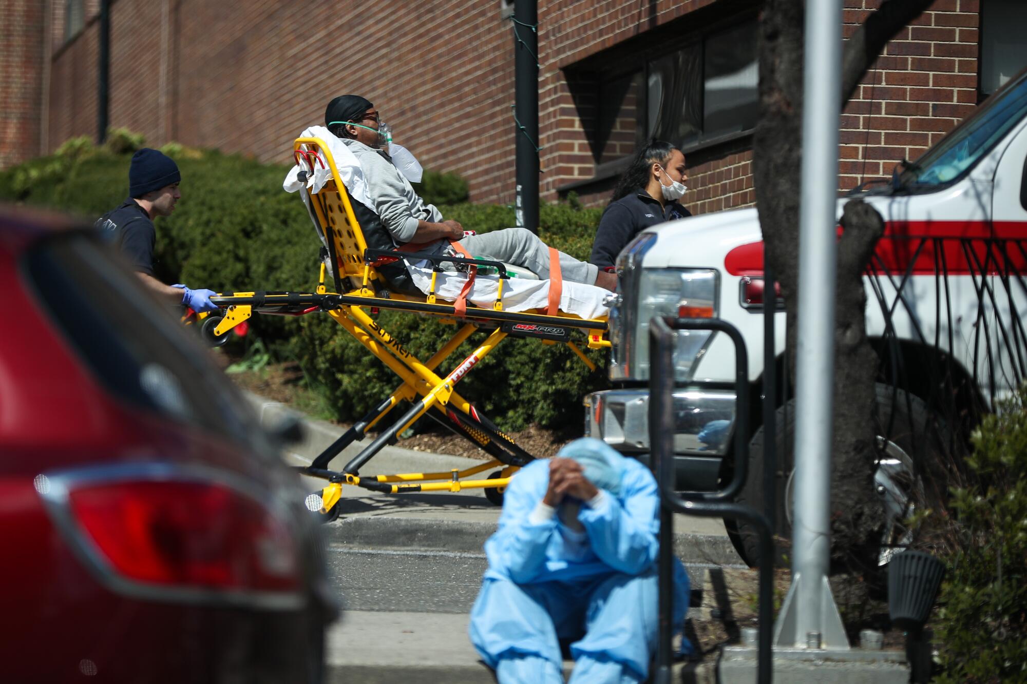 A tired healthcare worker by the Brooklyn Hospital Center in New York.