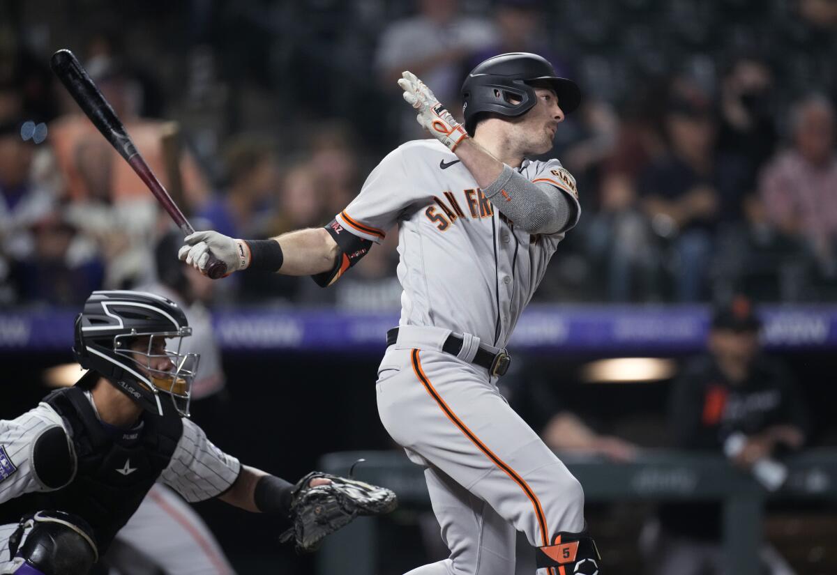 San Francisco Giants' Mike Yastrzemski watches his RBI single off Colorado Rockies relief pitcher Daniel Bard during the ninth inning of a baseball game Tuesday, Sept. 7, 2021, in Denver. The Giants won 12-3. (AP Photo/David Zalubowski)