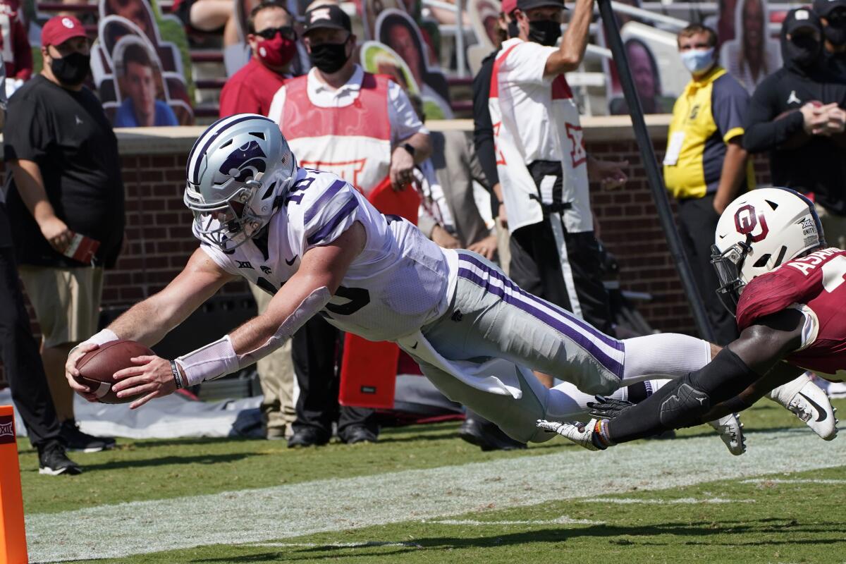 Kansas State QB Skylar Thompson dives into the end zone for a touchdown in front of Oklahoma linebacker Brian Asamoah.