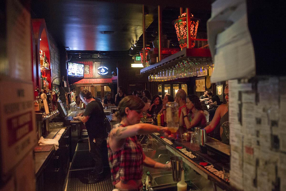 Bartenders work to fill everyone's orders at a crowed Small Bar on July 23, 2015. (Michael Cali)