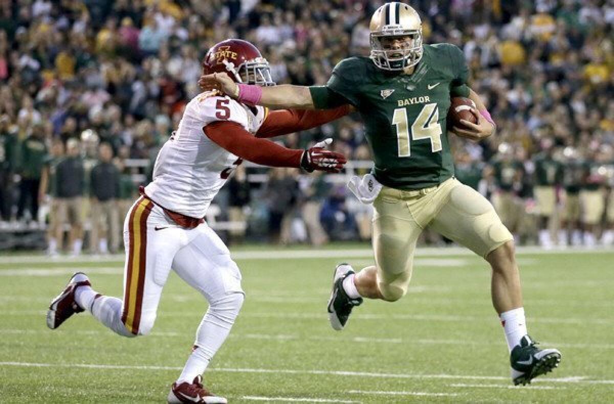 Baylor quarterback Bryce Petty (14) tries to elude Iowa State defensive back Jacques Washington during a game last month. Petty has led the Bears to an 8-0 record this season.