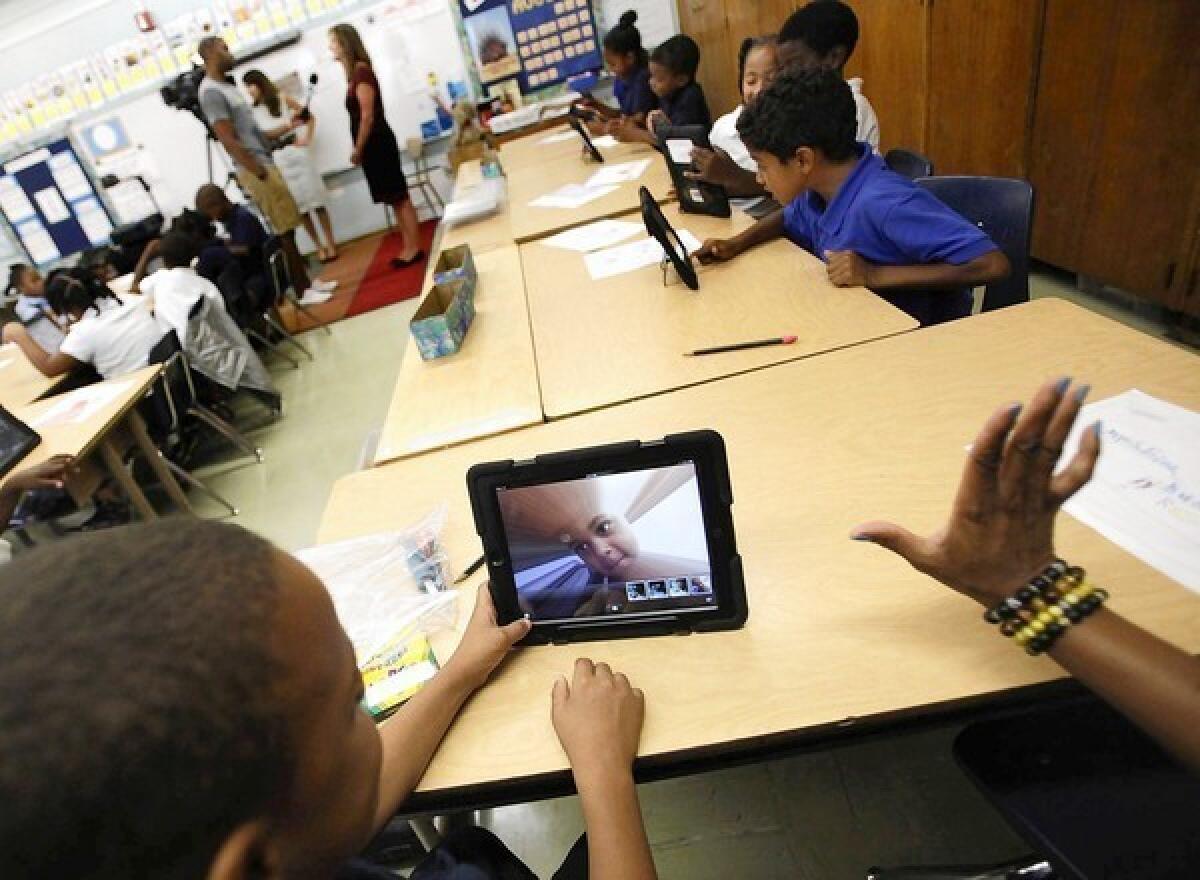 A student at Broadacres Elementary School in Carson, part of the Los Angeles Unified School District, experiments with his district-provided iPad's camera.