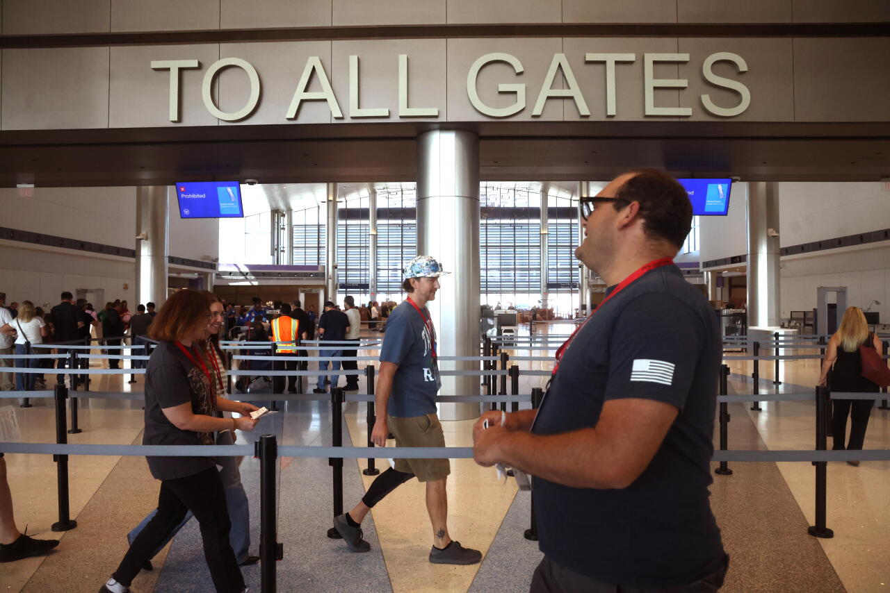 Volunteers, playing passengers, prepare to go through security at Hollywood Burbank Airport in Burbank on Sept. 19, 2026.