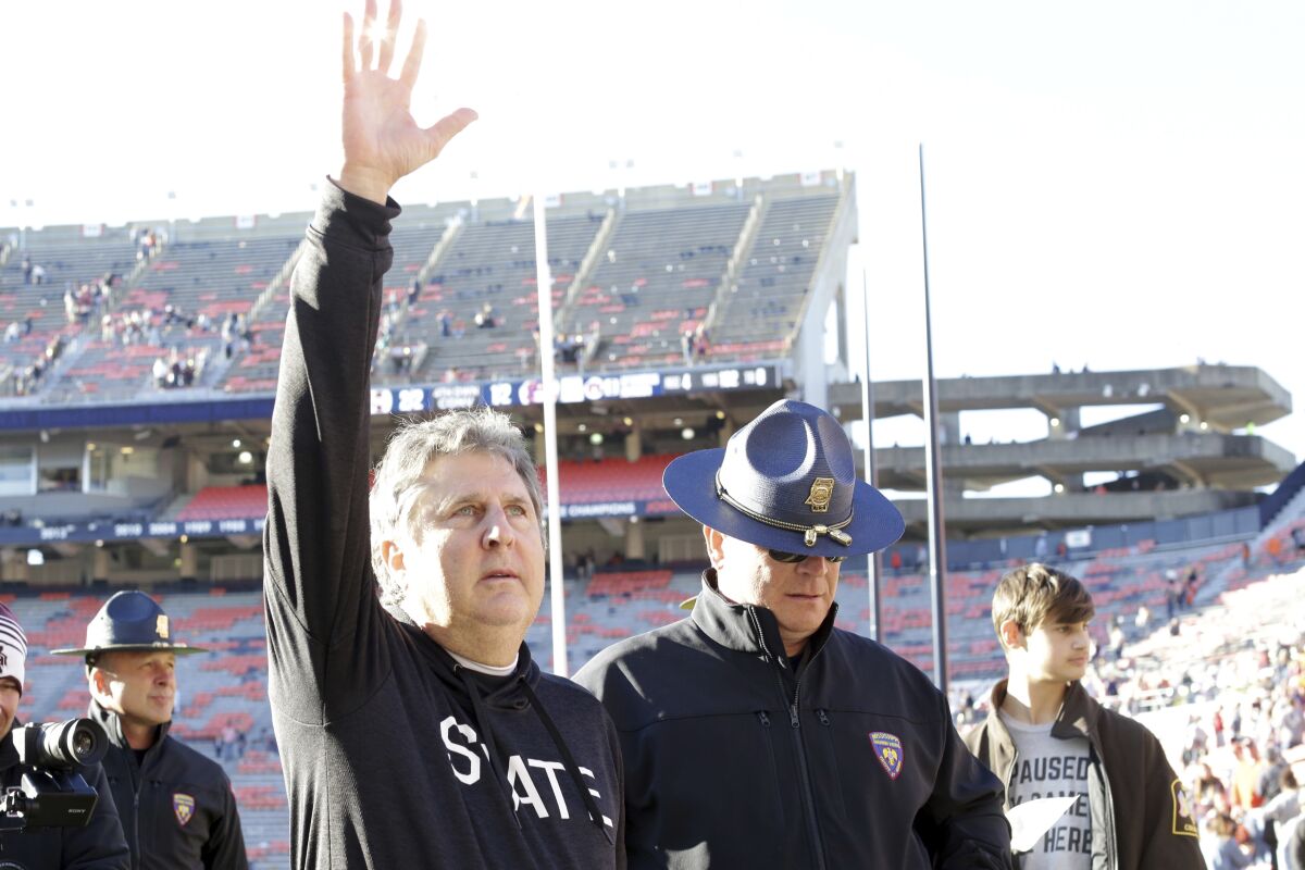 Mississippi State head coach Mike Leach waves to fans after they defeated Auburn in an NCAA college football game Saturday, Nov. 13, 2021, in Auburn, Ala. (AP Photo/Butch Dill)