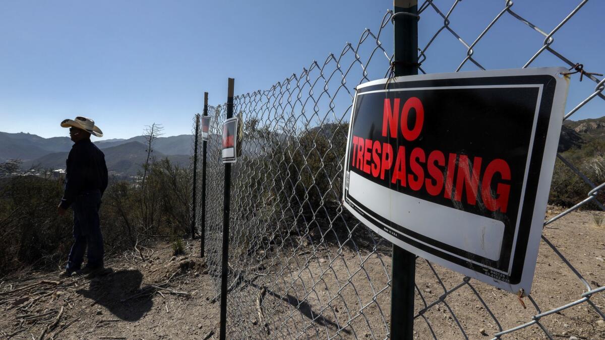 A section of the Los Robles trail system is marked by a "No trespassing" sign.