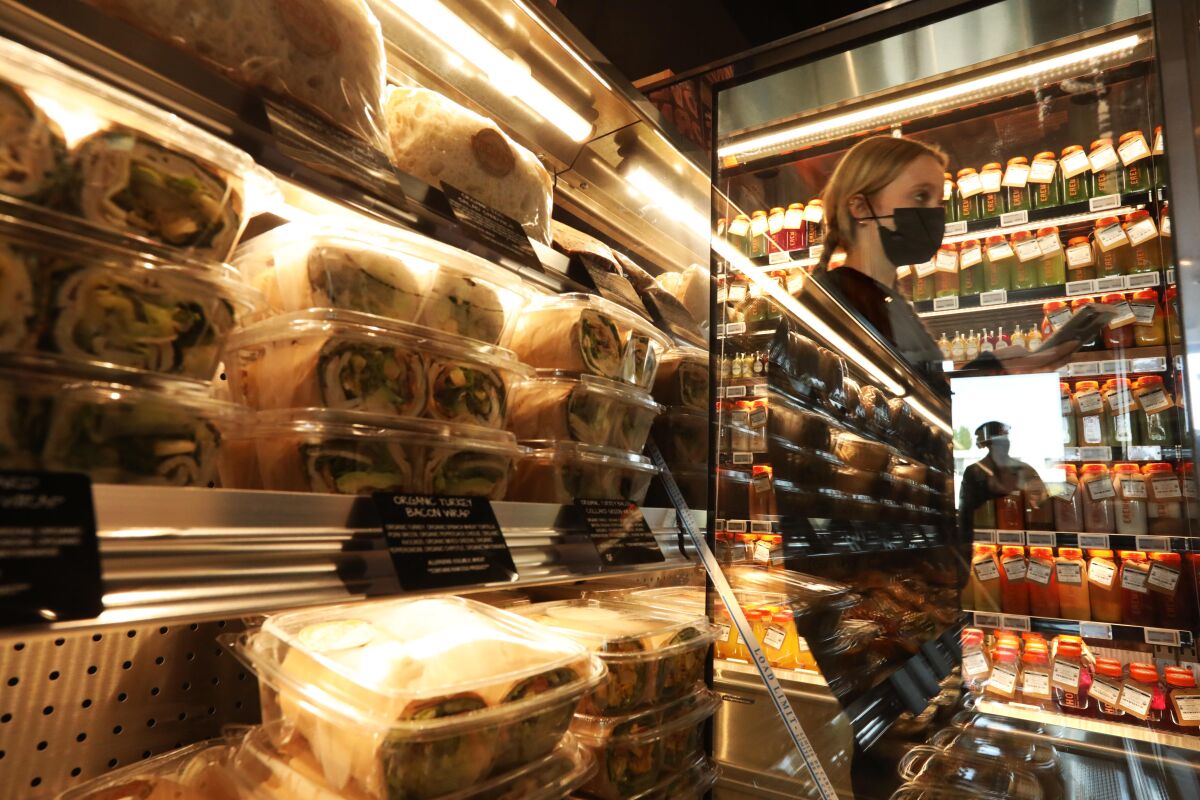 A shopper makes her way through the Erewhon health-food grocery store in Studio City on Nov. 18.