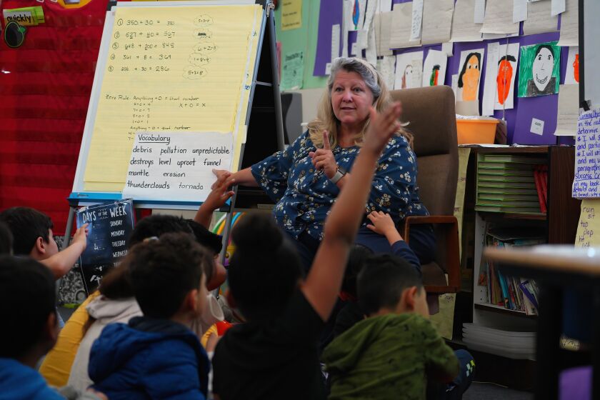 Dale Lees works on a classroom assignment with her 2nd grade students at Perkins K-8 school.San Diego Union-Tribune)