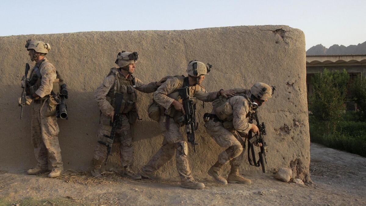 U.S. Marines move through a compound during a raid in Dahaneh, Afghanistan on Aug. 15, 2009.