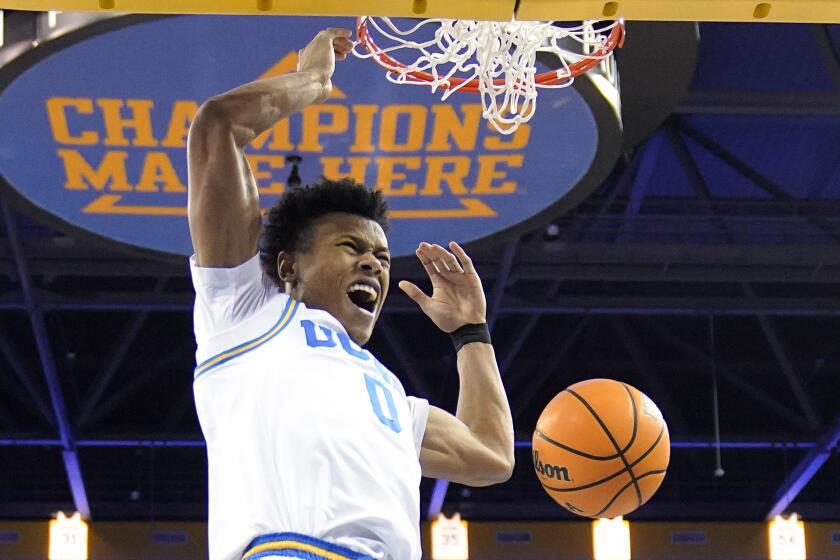 UCLA guard Jaylen Clark dunks during the first half of an NCAA college basketball game.