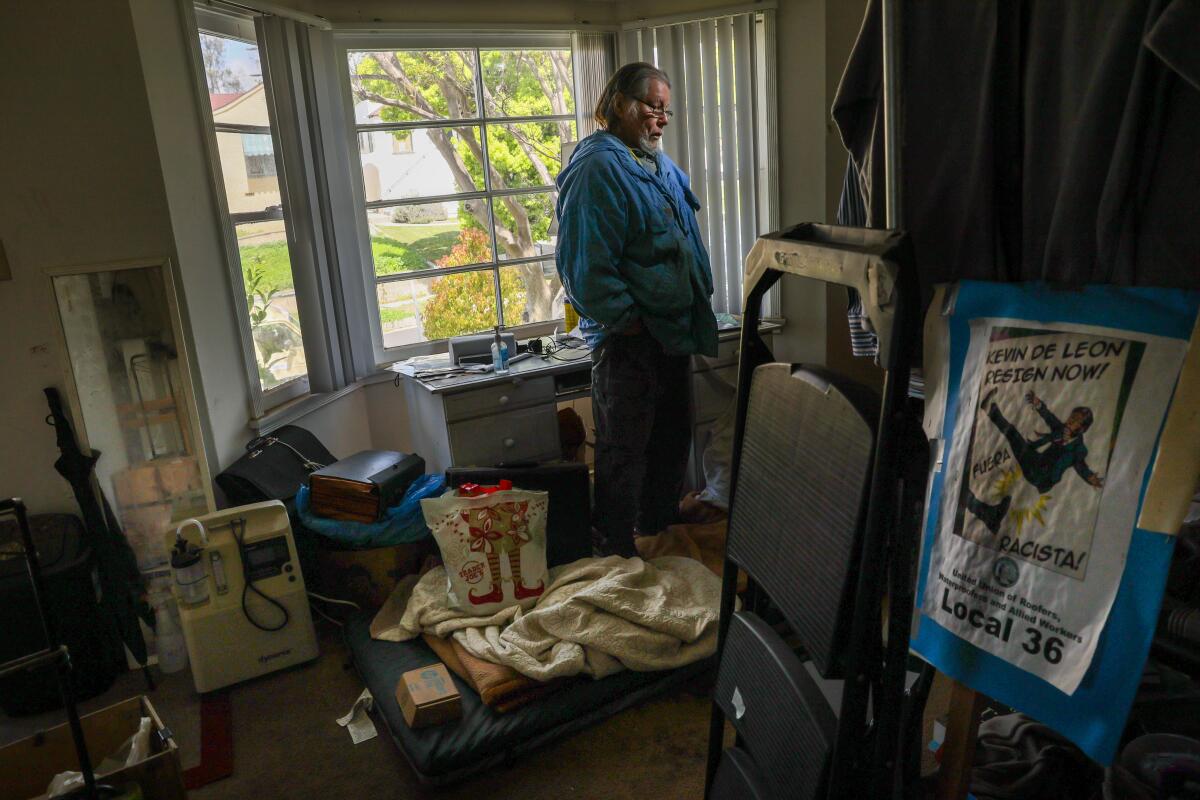 A man stands inside his home in El Sereno.