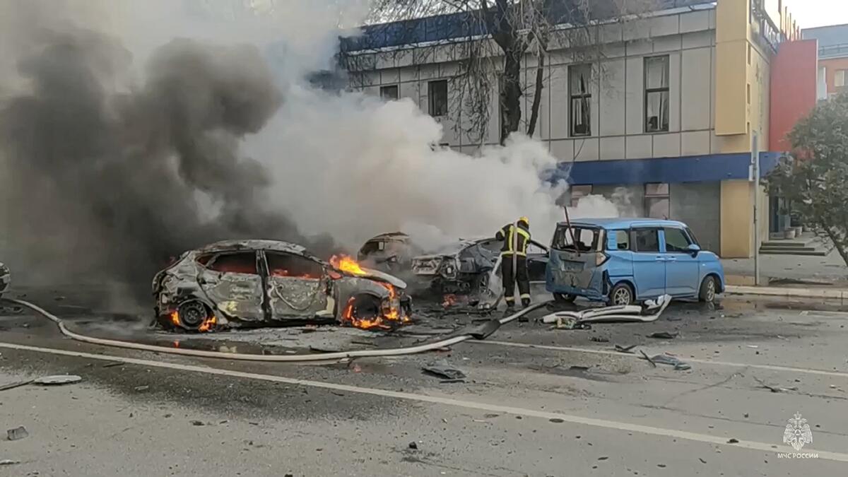 Firefighters extinguish burning cars after shelling in Belgorod, Russia. 