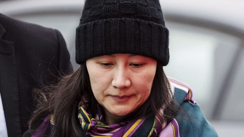 Meng Wanzhou, Huawei chief financial officer, arrives at a parole office with a security guard in Vancouver in December.