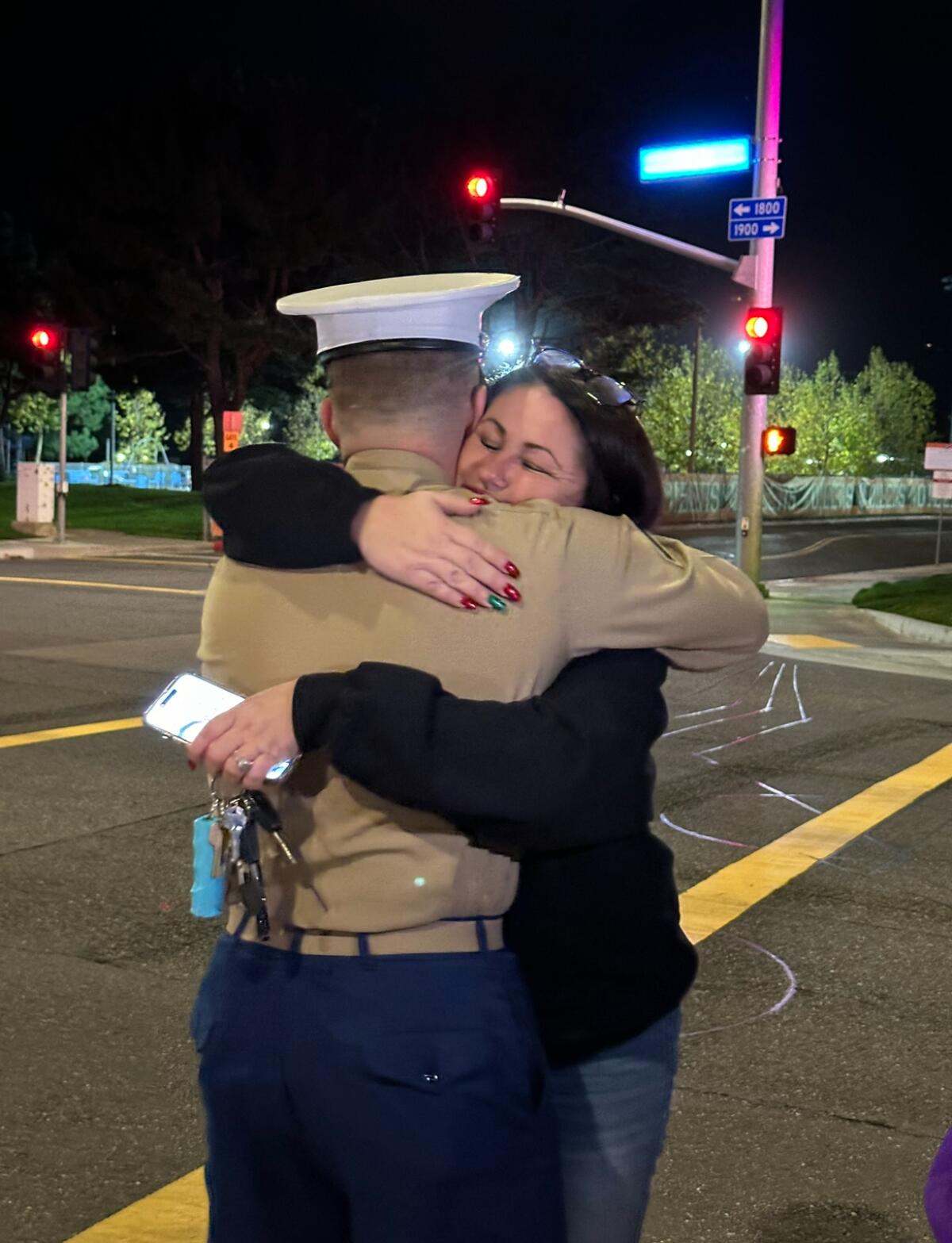 Laura Costelloe hugs U.S. Marine Alexe Pappageorge Jr. 