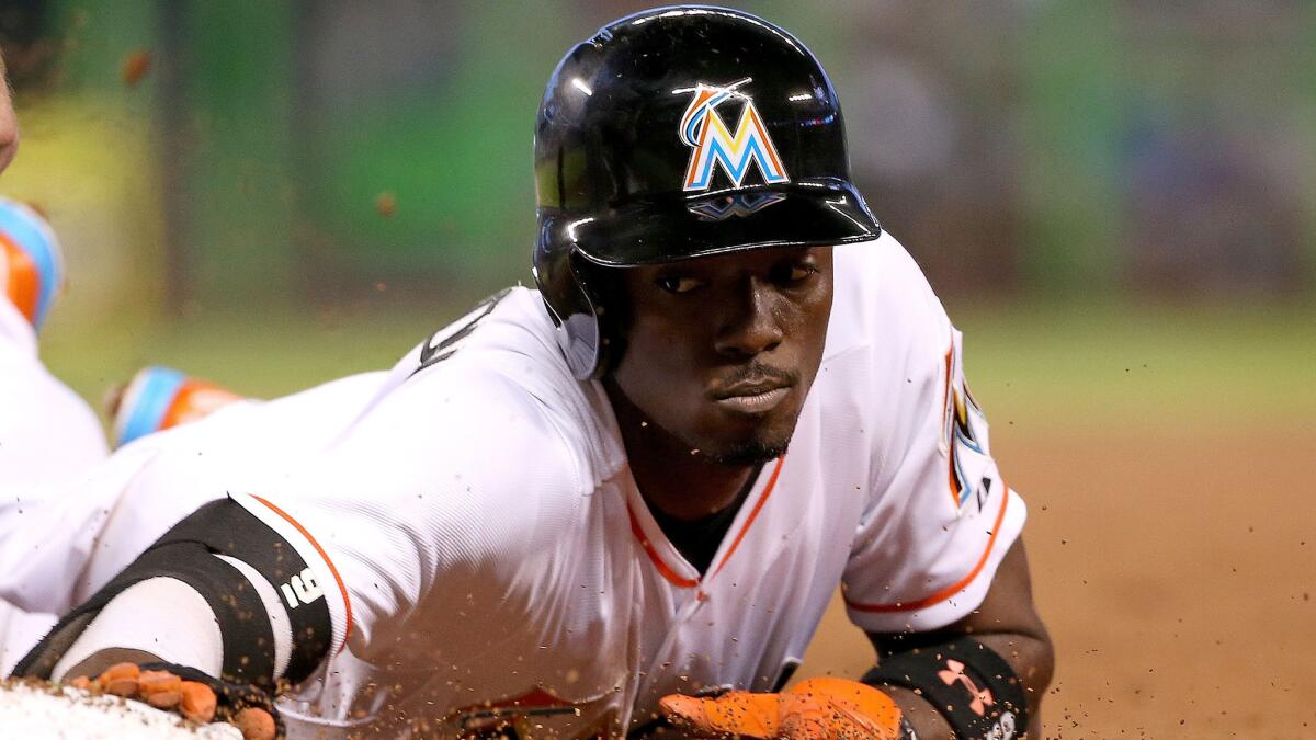 Miami Marlins second baseman Dee Gordon slides safely back to first during a game against the New York Mets on April 29.