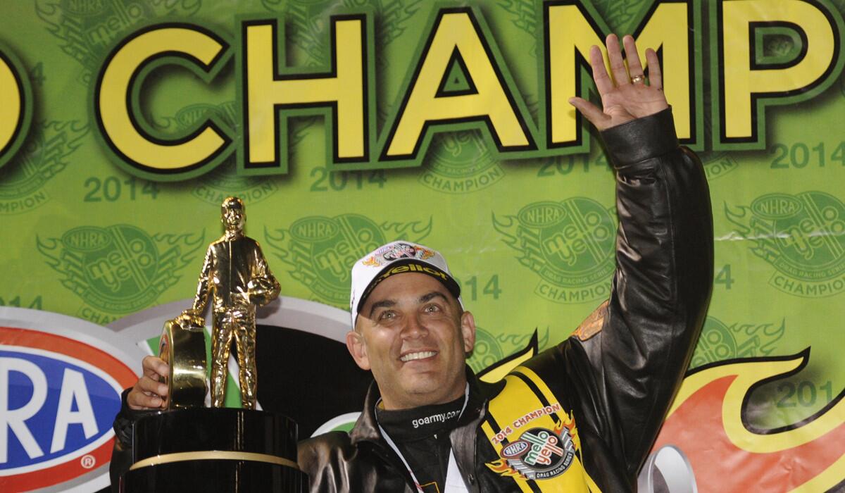 Tony Schumacher celebrates his NHRA Top Fuel title following qualifying Saturday at the NHRA Finals in Pomona.