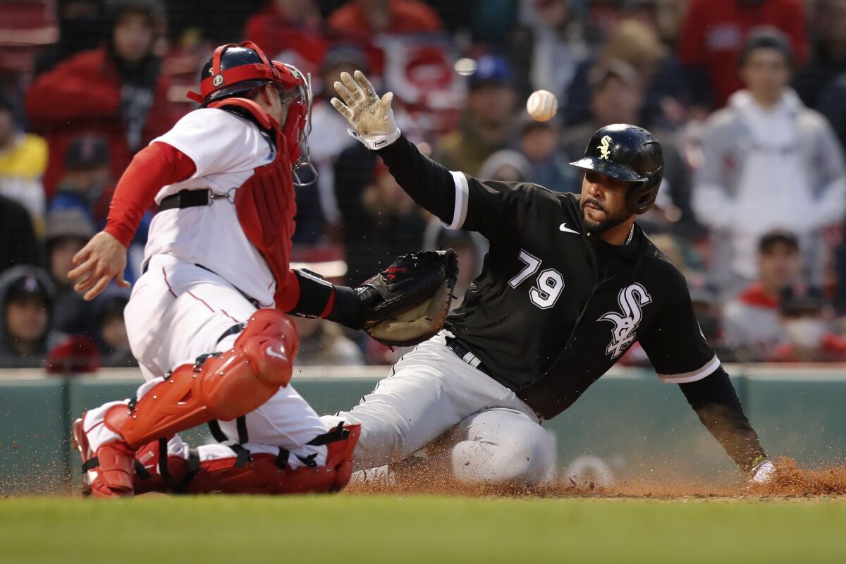 Chicago White Sox's Jose Abreu (79) is safe at home plate against Boston Red Sox's Christian Vazquez on the single by Luis Robert during the 10th inning of a baseball game, Saturday, May 7, 2022, in Boston. (AP Photo/Michael Dwyer)