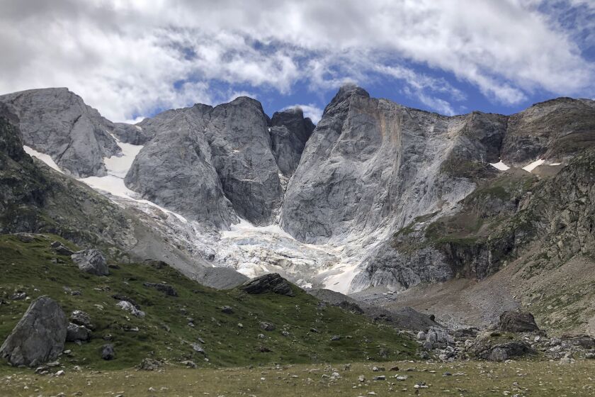 FILE - A view of the Petit Vignemale glacier, left, and the Oulettes, right, on the Vignemale massif's north face in the Pyrenean mountain range, as seen from the Gaube valley in southern France, Sunday, Aug. 3, 2020. Spanish environmental groups on Monday, March 20, 2023, called on the European Union to open an inquiry into the approval of 26.4 million euros ($28.1 million) of “green” economic recovery funds to join two ski resorts in the rapidly warming Pyrenees mountain range. (AP Photo/Aritz Parra, File)