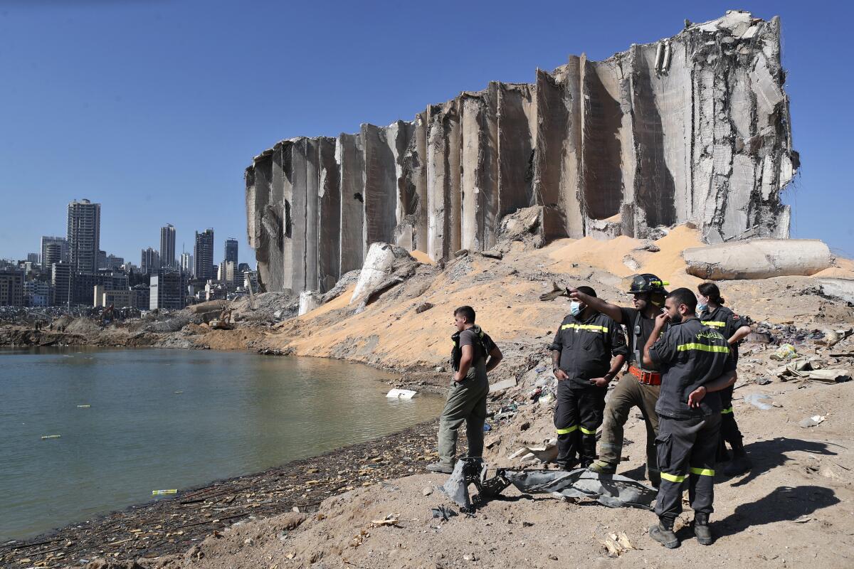 FILE - A rescue team surveys the site of a massive explosion in the port of Beirut, Lebanon, Aug. 7, 2020. Families of some of the victims of Beirut’s deadly port blast have filed a $250 million lawsuit against an American-Norwegian firm suspected of involvement in bringing the explosive material to the port, a Swiss foundation announced Wednesday, July 13, 2022. Accountability Now, which says its mission is to support Lebanese civil society efforts to put an end to the impunity of the country's leaders, said the lawsuit was filed Monday. (AP Photo/Thibault Camus, File)
