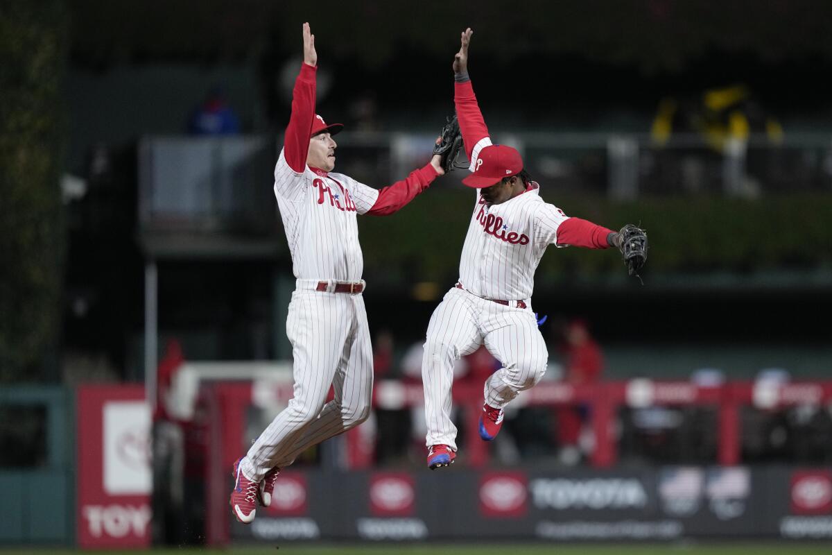 Philadelphia's Jean Segura and Bryson Stott celebrate after the Phillies' win in Game 4 of the NLCS on Saturday.