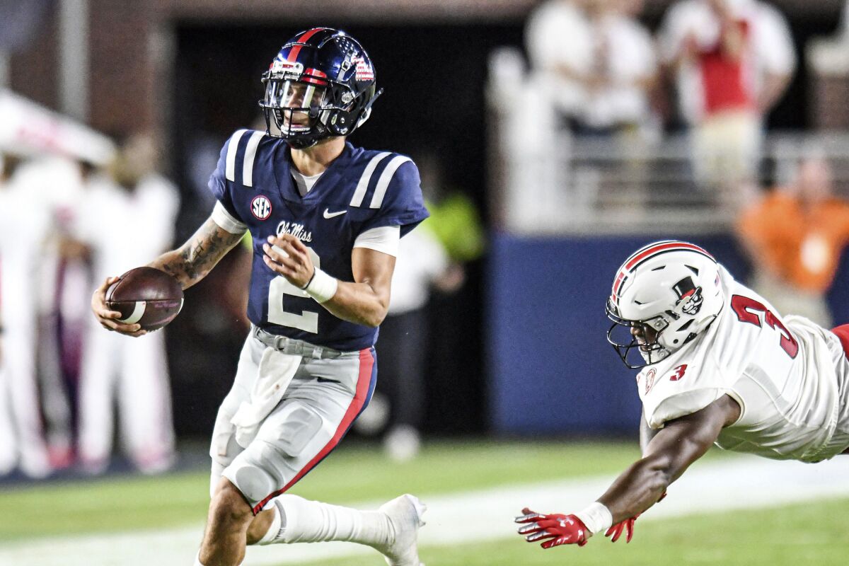 Mississippi quarterback Matt Corral (2) runs past Austin Peay's Jau'von Young (3) during an NCAA college football game in Oxford, Miss., Saturday, Sept. 11, 2021. (AP Photo/Bruce Newman)