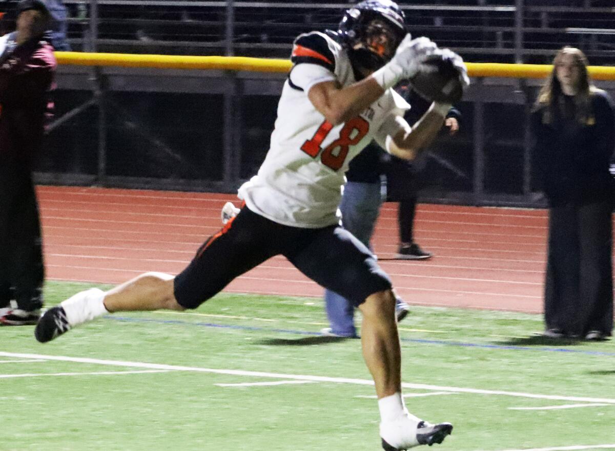 Huntington Beach's Troy Foster (18) makes a catch for a touchdown against Simi Valley on Friday.