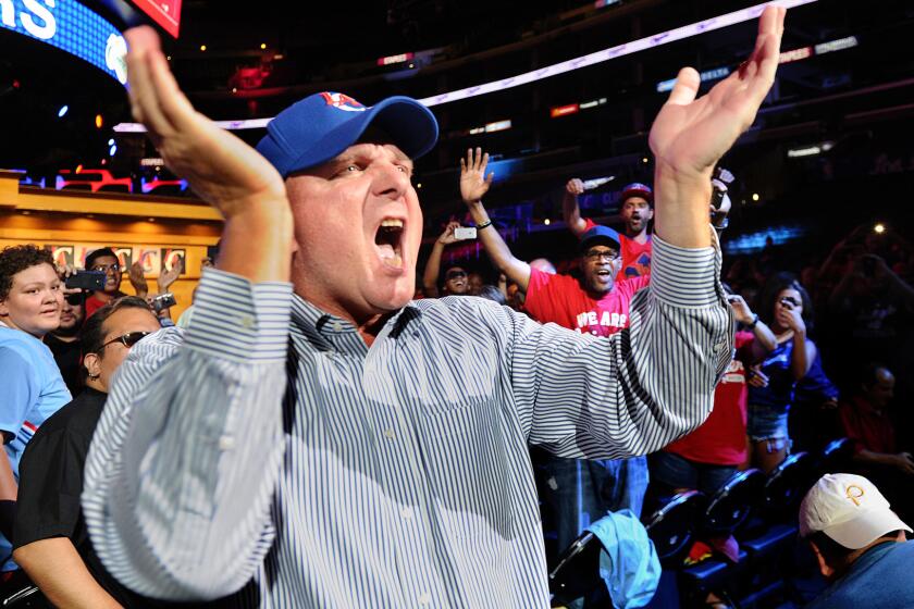 New Clippers owner Steve Ballmer cheers as he greets fans during a rally at Staples Center on Monday.