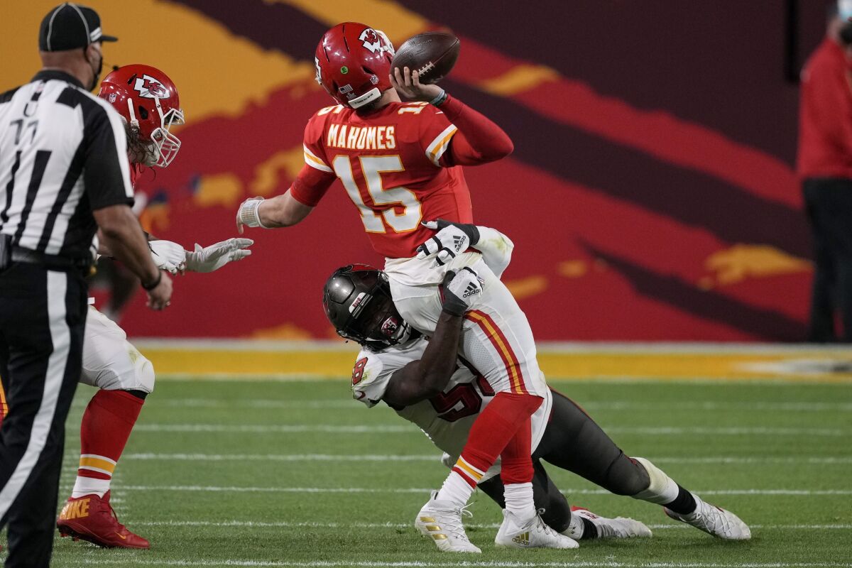 Kansas City Chiefs quarterback Patrick Mahomes passes on fourth down as he's tackled.