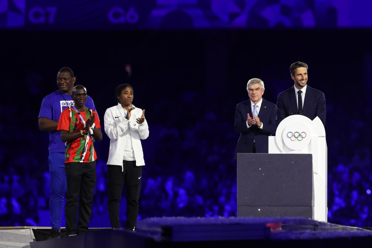 Paris 2024 organizing committee president Tony Estanguet delivers a speech in front of IOC president Thomas Bach 