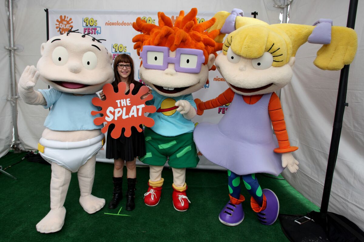 Singer Lisa Loeb, second from left, and "Rugrats" characters attend the Nickelodeon-sponsored 90sFEST Pop Culture and Music Festival.