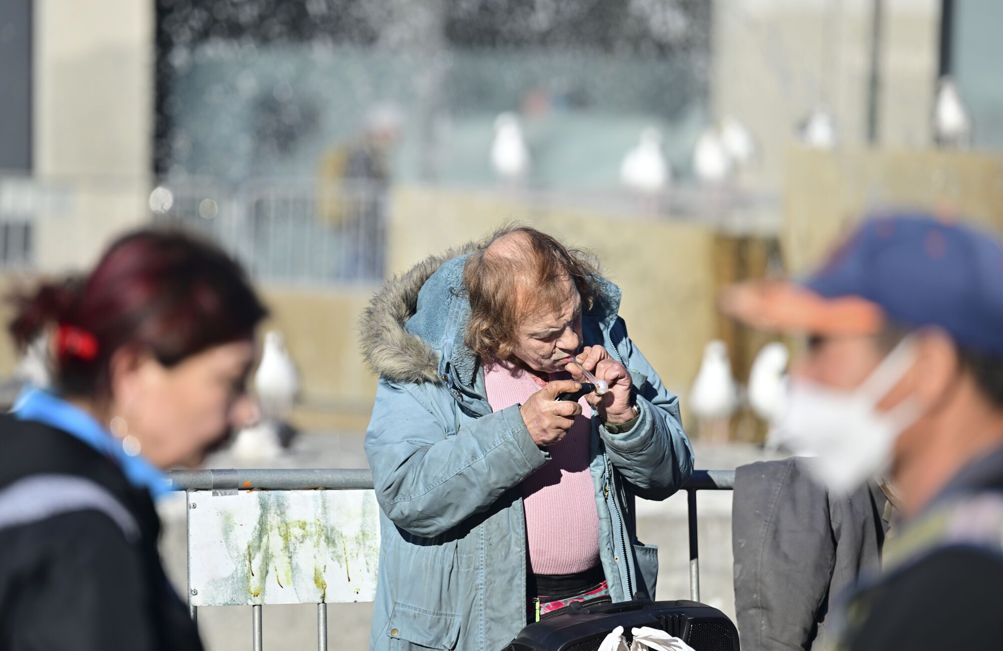 A person smokes an illegal substance at UN Plaza in San Francisco on Dec. 17.