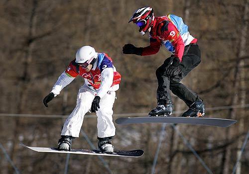 Seth Wescott keeps his lead over Radoslav Zidek of Slovakia as they head toward the finish of the Men's Snowboardcross Finals at Bardonecchia. Wescott won the Gold Medal and Zidek won the Silver.