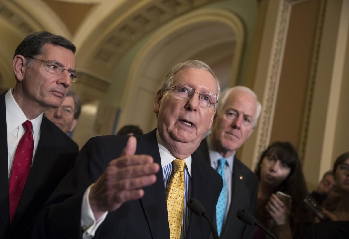 Senate Majority Leader Mitch McConnell (R-Ky.) flanked by Sen. John Barrasso (R-Wyo.), left, and Majority Whip John Cornyn (R-Texas) at the Capitol.